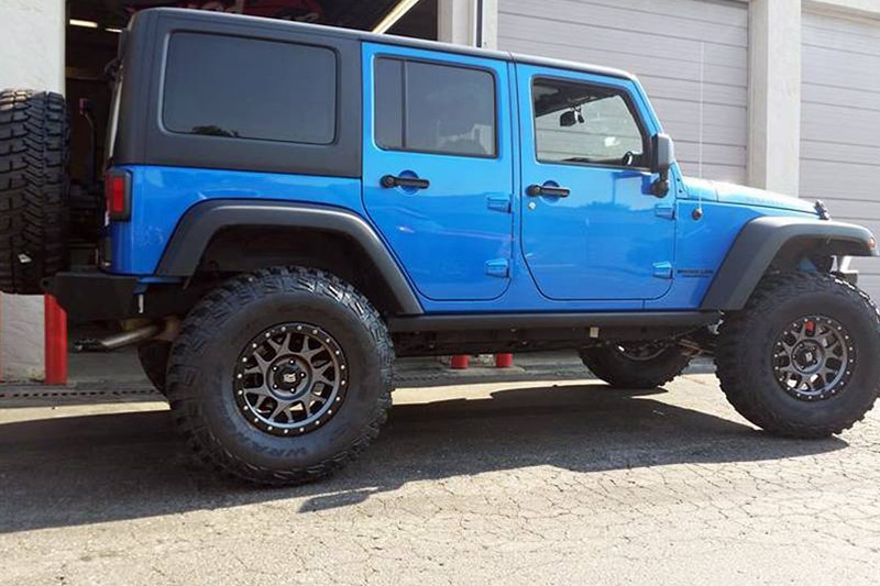 Blue jeep with list and custom wheels